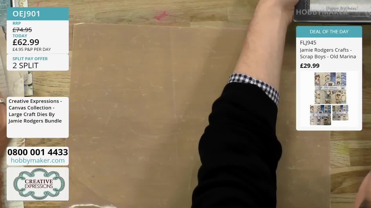 A hand reaches out, holding a stamp. The stamp is from Hobby Maker, a UK company.