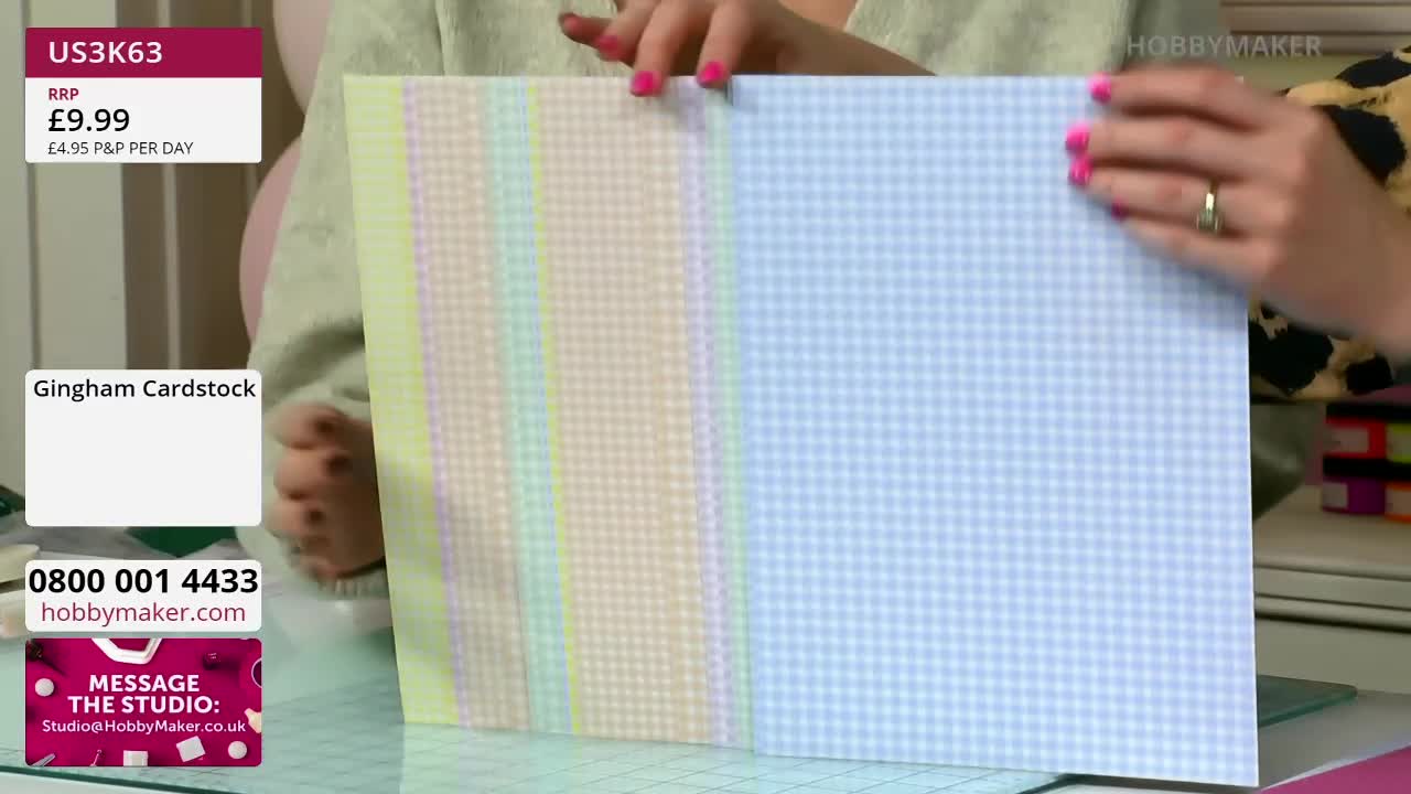 Hands with bright pink nail polish adjust a stack of pastel gingham cardstock. The sheets are fanned out, revealing pale yellow, green, peach, and blue patterns.
