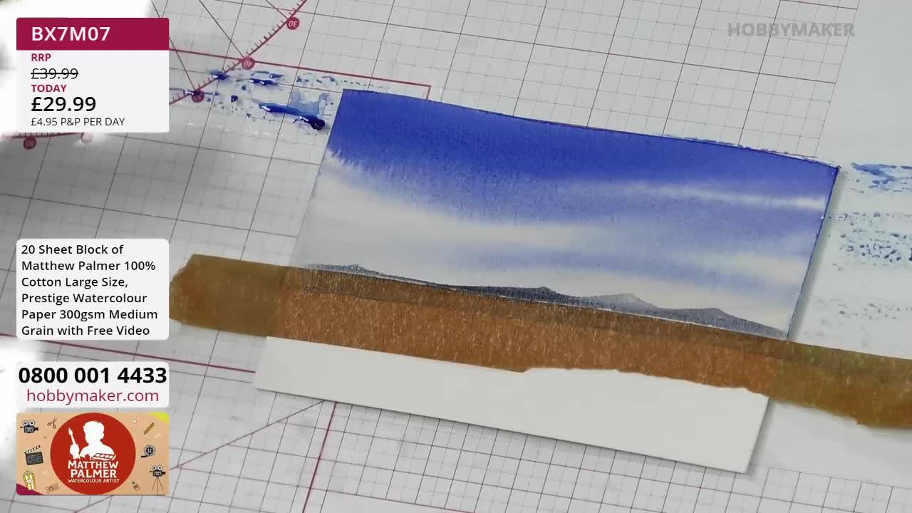 A watercolour painting of a sky and distant hills is being worked on. The artist is using a piece of masking tape to create a clean edge on the paper. A watercolour painting of a sky and distant hills is being worked on. The artist is using a piece of masking tape to create a clean edge on the paper.