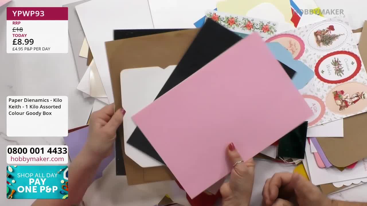 Hands are sifting through a pile of colourful cardstock, revealing a sheet of bright pink paper. A stack of assorted craft papers, including brown and black, sits beneath it. Hands are sifting through a pile of colourful cardstock, revealing a sheet of bright pink paper. A stack of assorted craft papers, including brown and black, sits beneath it.