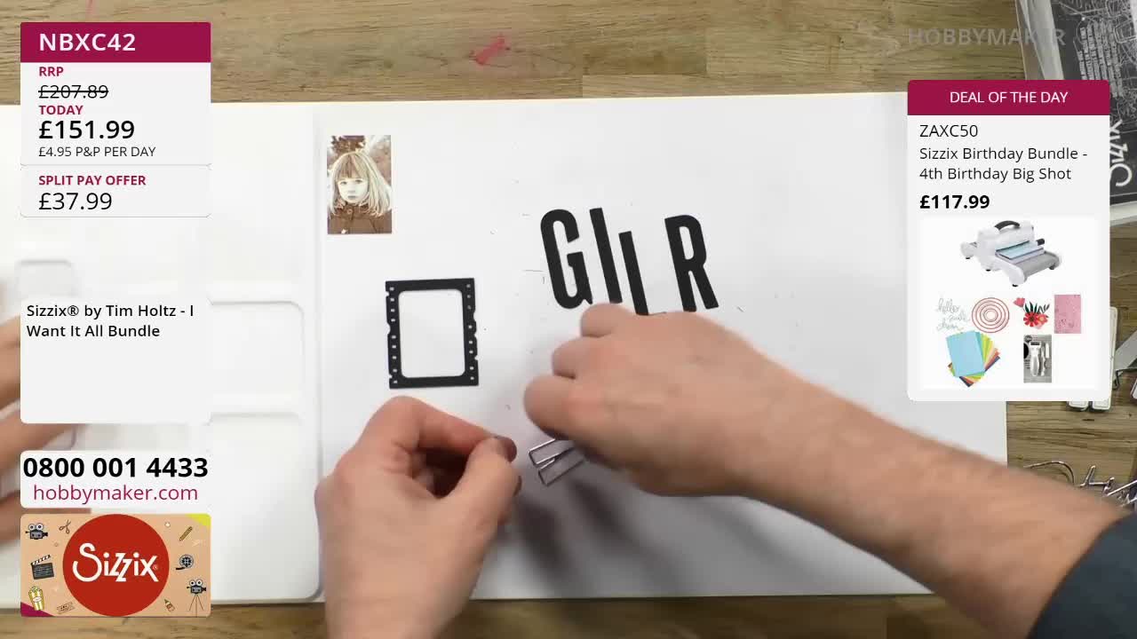 Hands are arranging black letter cutouts on a white surface. A small, framed photograph of a child sits to the left of the letters. Hands are arranging black letter cutouts on a white surface. A small, framed photograph of a child sits to the left of the letters.