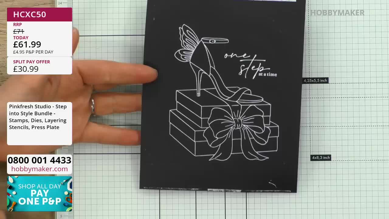 A hand is holding up a black card with a white outline of a high-heeled shoe, stacked gift boxes, and a bow. The text "one step at a time" is written in cursive above the shoe. A hand is holding up a black card with a white outline of a high-heeled shoe, stacked gift boxes, and a bow. The text "one step at a time" is written in cursive above the shoe.