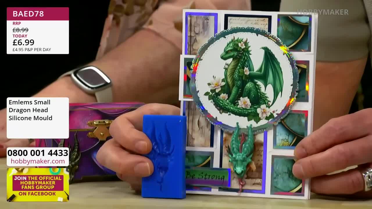 A hand holds up a bright blue silicone mould, showcasing the dragon head imprint. Beside it, a finished card features a detailed green dragon surrounded by delicate white flowers. A hand holds up a bright blue silicone mould, showcasing the dragon head imprint. Beside it, a finished card features a detailed green dragon surrounded by delicate white flowers.