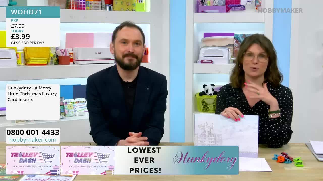 A man with a beard smiles directly at me. Beside him, a woman gestures with her hands, holding up a card insert.