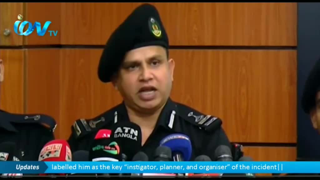 A man in a black uniform and beret speaks into a cluster of microphones, his mouth open as he addresses the cameras. The Ion TV logo is visible in the corner, and a caption below the screen labels him as a key figure.
