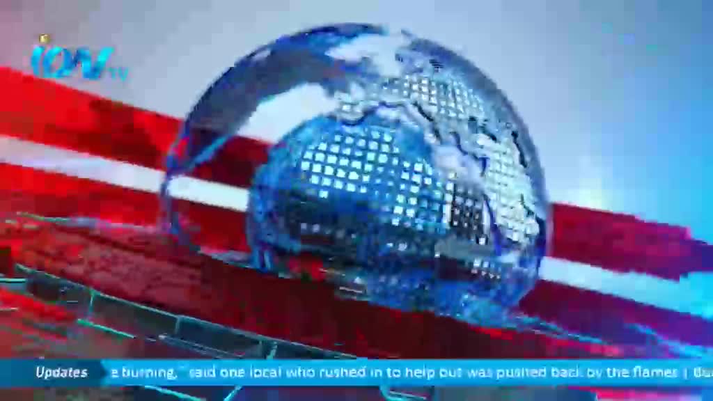 A rotating, pixelated globe sits atop red and white bars, the Ion TV logo visible in the corner. Below, a news ticker scrolls across the screen.
