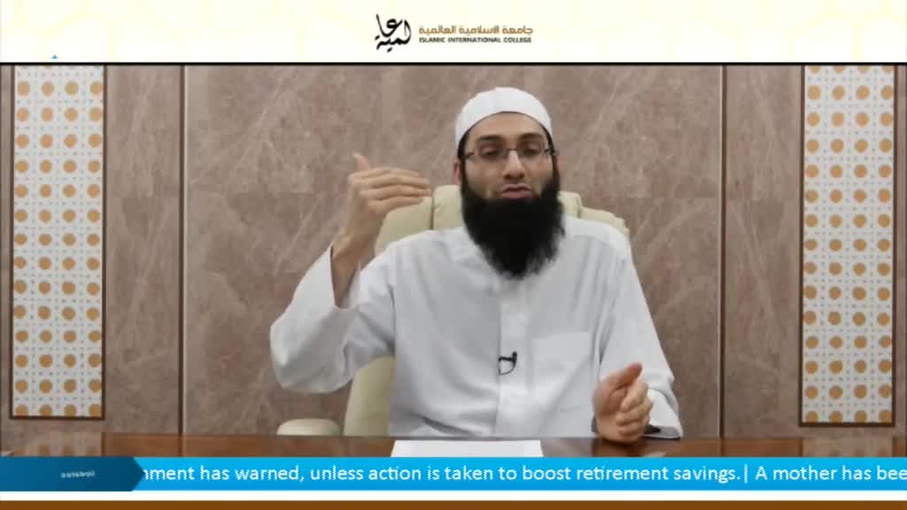 A man in a white shirt and cap gestures with his right hand while speaking. The lower third of the screen displays a news ticker.
