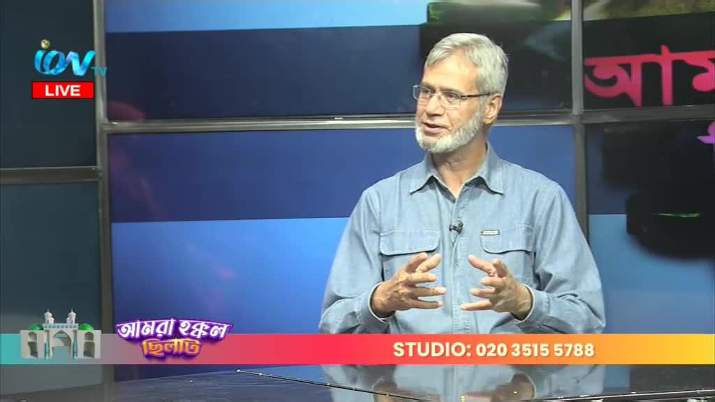 A man with a gray beard and glasses gestures with his hands as he speaks on Ion TV. The studio backdrop is a mix of blue panels and colorful graphics.
