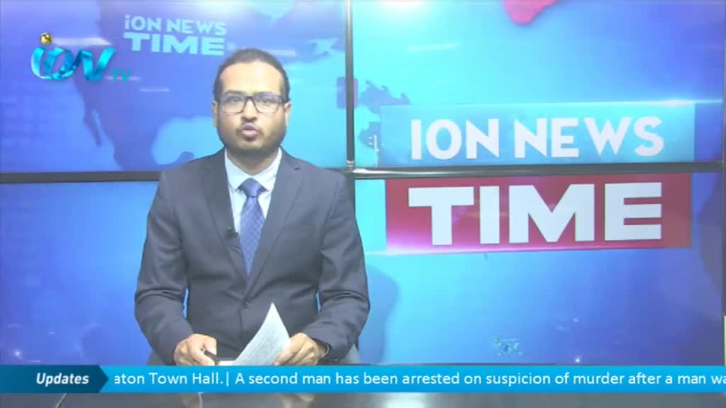 A man in a suit and tie is speaking, holding a paper, with the "ION News Time" logo behind him. The bottom of the screen displays a news headline about an arrest in the United Kingdom.
