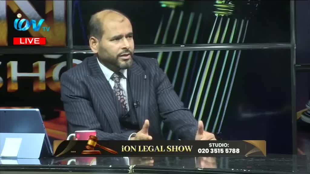 The man in the pinstripe suit gestures with both hands as he speaks on the Ion Legal Show, airing live from a studio in the United Kingdom. A tablet and a gavel sit on the desk in front of him.
