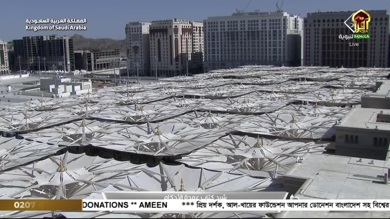 From this vantage point, I see a vast expanse of white, tent-like structures covering the ground. The scene is being broadcast live by Iqra TV from the Kingdom of Saudi Arabia.
