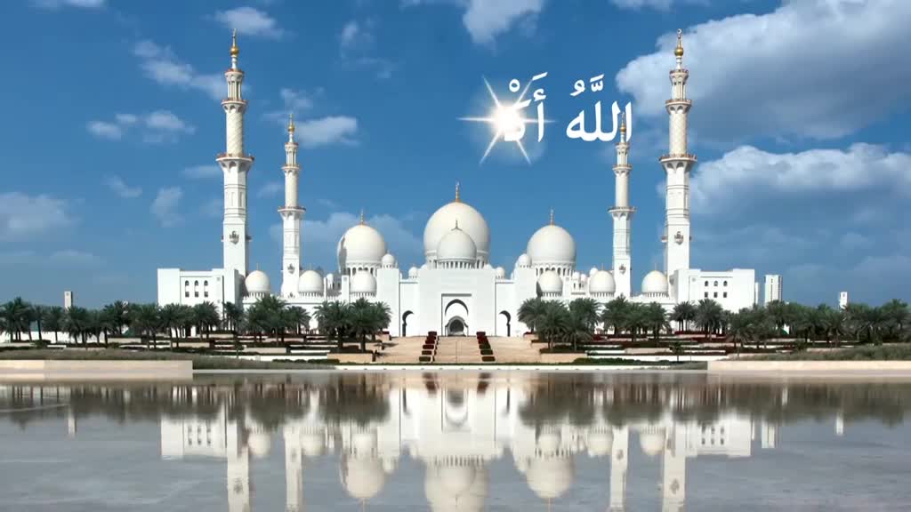 A grand mosque, gleaming white, stands tall against a bright blue sky. Its reflection shimmers in the still water below, creating a symmetrical scene.

