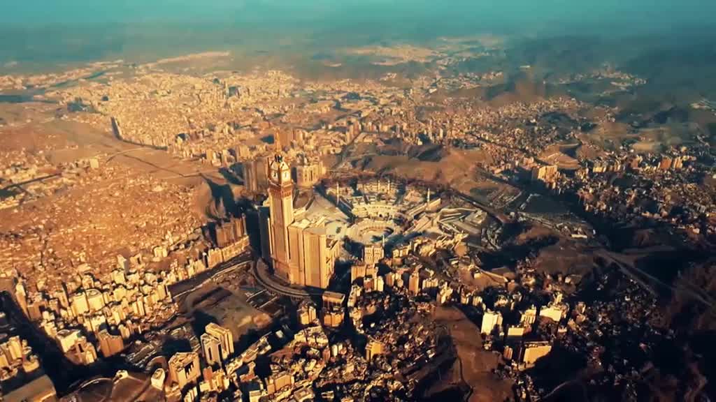 The city sprawls out, a sea of buildings under a hazy sky. A tall clock tower stands out, its shadow stretching across the landscape.
