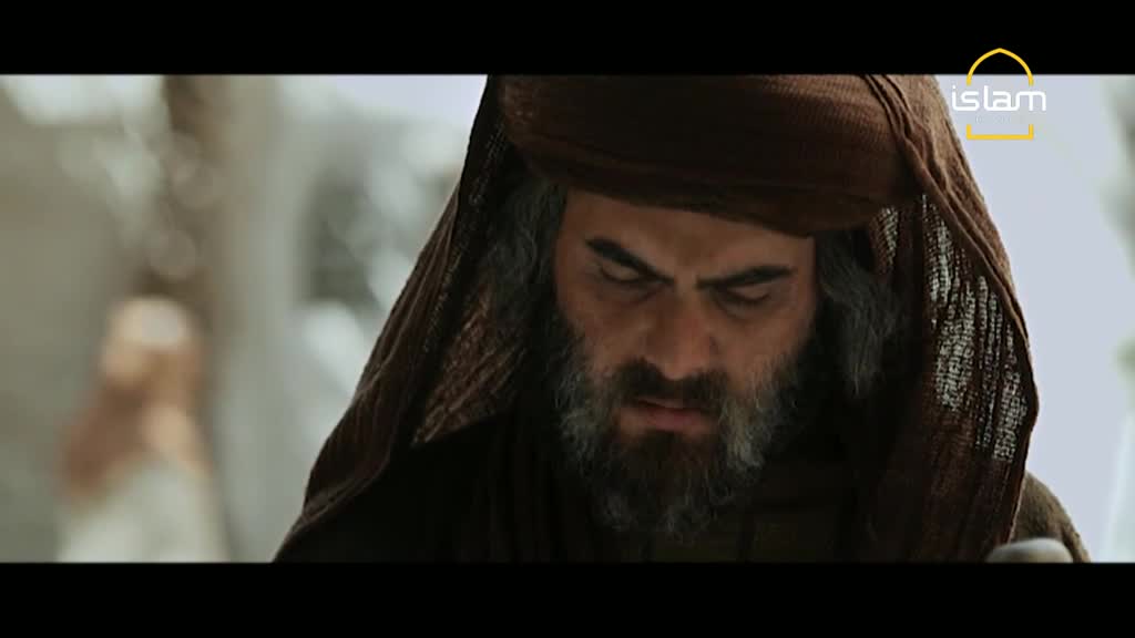 A man with a long, grey beard stares down, his face etched with concern. The Islam Channel logo is visible in the corner, suggesting a scene from a historical drama.
A man with a long, grey beard stares down, his face etched with concern. The Islam Channel logo is visible in the corner, suggesting a scene from a historical drama.