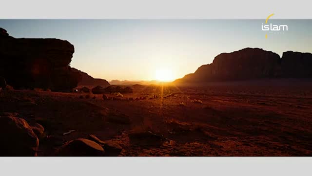 The sun is rising, casting long shadows across the desert landscape. Silhouetted mountains frame the bright light, and a logo from Islam Channel is visible in the corner.
