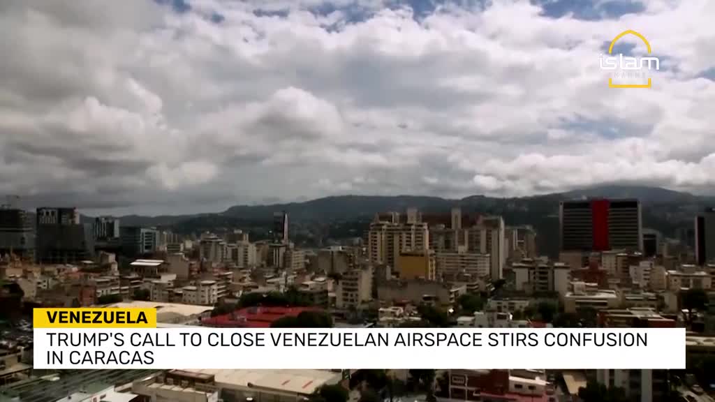 Above a city skyline, thick clouds drift across the sky. The Islam Channel logo sits in the upper right corner, while the lower third of the screen displays a news headline about Venezuela.
