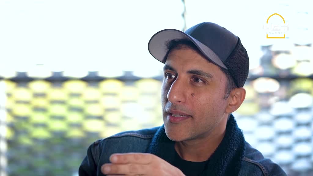 A man wearing a baseball cap and denim jacket gestures with his right hand as he speaks. The logo from the Islam Channel in the United Kingdom is visible in the corner.
