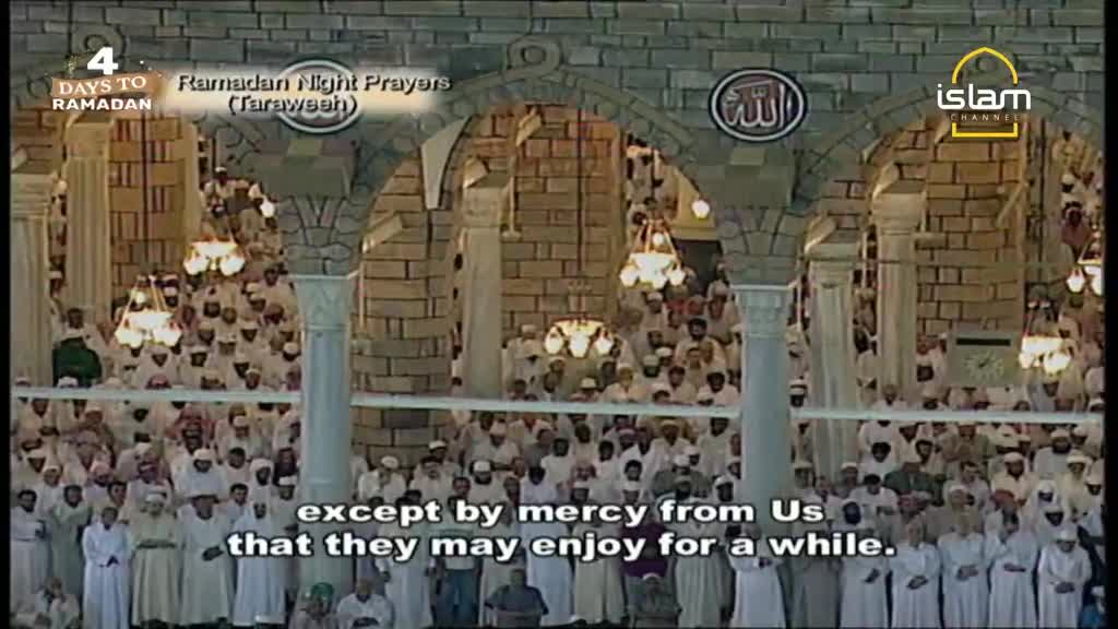 A vast crowd of men in white robes stand shoulder to shoulder, their heads bowed in prayer. The air is thick with devotion as they perform Tarawih prayers, a special observance during Ramadan.