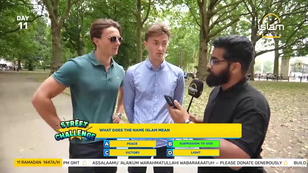 A man with a beard holds a microphone and a phone, speaking to two young men in a park. A yellow banner behind them asks, "WHAT DOES THE NAME ISLAM MEAN."