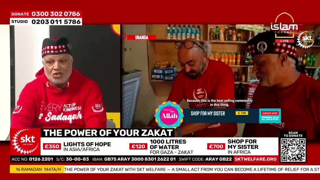 A man in a red hoodie speaks directly to the camera while two other men in red shirts stand behind him, one looking down at a shelf. The screen displays donation information for SKT Welfare, a charity operating in the UK.
