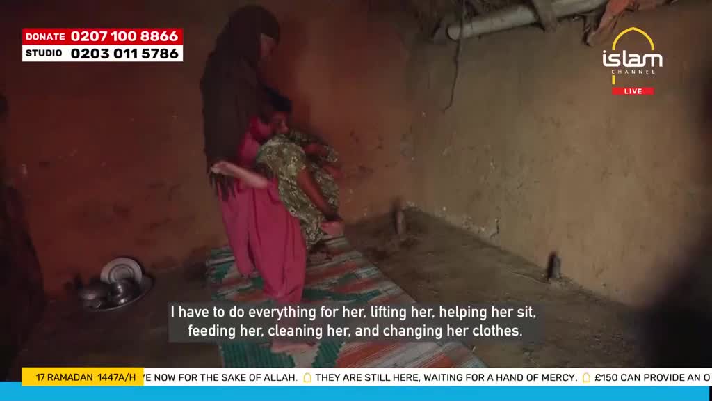 A woman in a hijab carefully lifts a child into a sitting position on a mat. The Islam Channel logo is visible in the upper right corner.