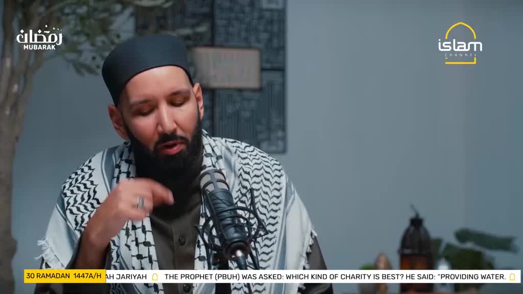 A man with a beard and a black cap speaks into a microphone, his hand gesturing. The Islam Channel logo appears on screen, alongside text about Ramadan. A man with a beard and a black cap speaks into a microphone, his hand gesturing. The Islam Channel logo appears on screen, alongside text about Ramadan.