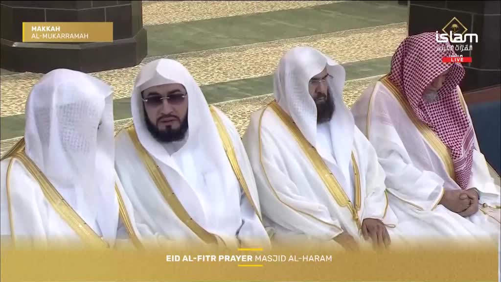 Four men in white thobes and head coverings sit together, their hands resting in their laps. The man on the far right wears a red and white checkered ghutra. Four men in white thobes and head coverings sit together, their hands resting in their laps. The man on the far right wears a red and white checkered ghutra.