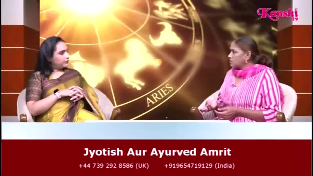 Two women sit in armchairs, engaged in a conversation on Kanshi TV. The backdrop features a golden design with the word "ARIES" visible, and the show's title and contact information are displayed below.
