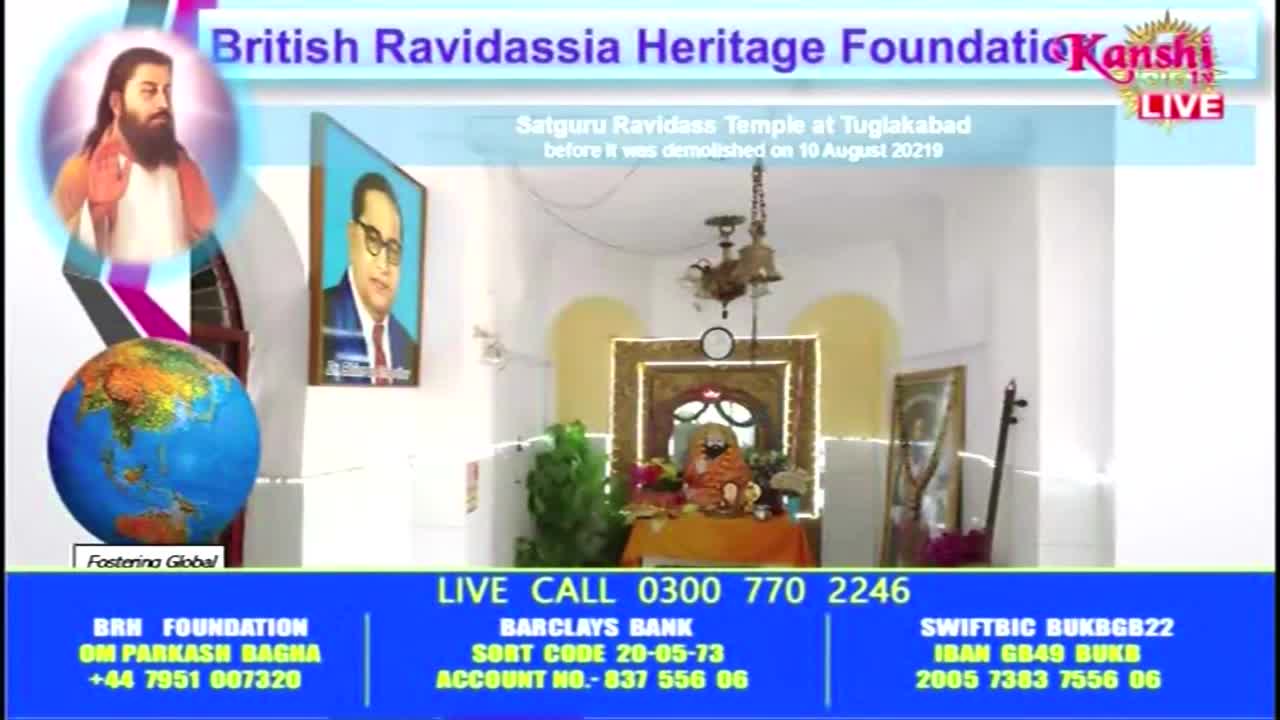 Kanshi TV is broadcasting from a brightly lit room, with a framed portrait of a man in glasses and a small shrine visible. The screen also displays information for the British Ravidassia Heritage Foundation.
