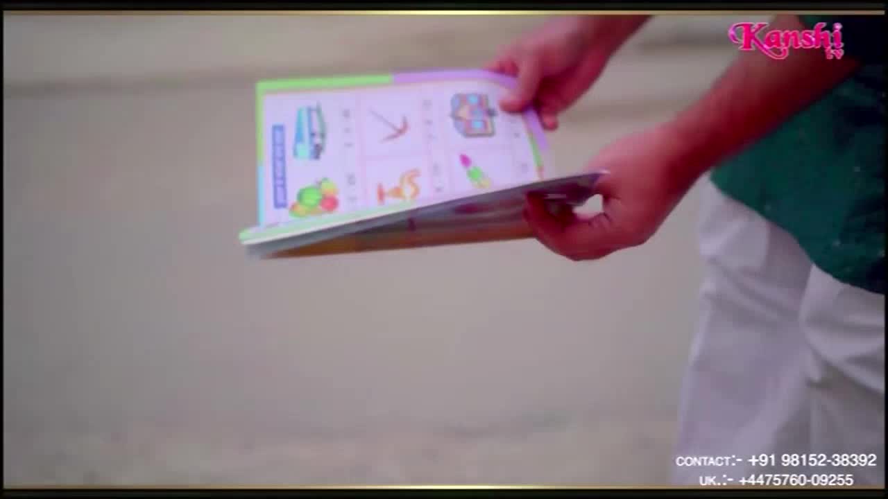 Someone is holding open a colorful book, the pages filled with drawings of objects. The scene is from Kanshi TV, with contact information for the United Kingdom displayed at the bottom of the screen.
