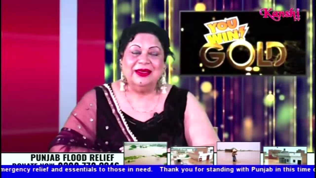 A woman with bright red lipstick smiles warmly at the camera on Kanshi TV. Below her, a banner promotes Punjab flood relief efforts, with small images of flooded areas.
