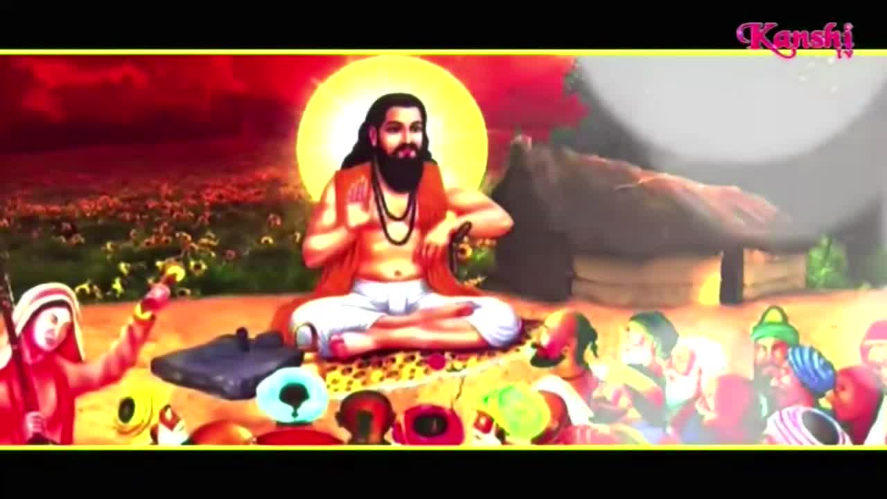 A robed figure with a halo sits cross-legged, gesturing with his hands. Around him, a crowd of people in colorful headwear and robes gathers, as seen on Kanshi TV.
