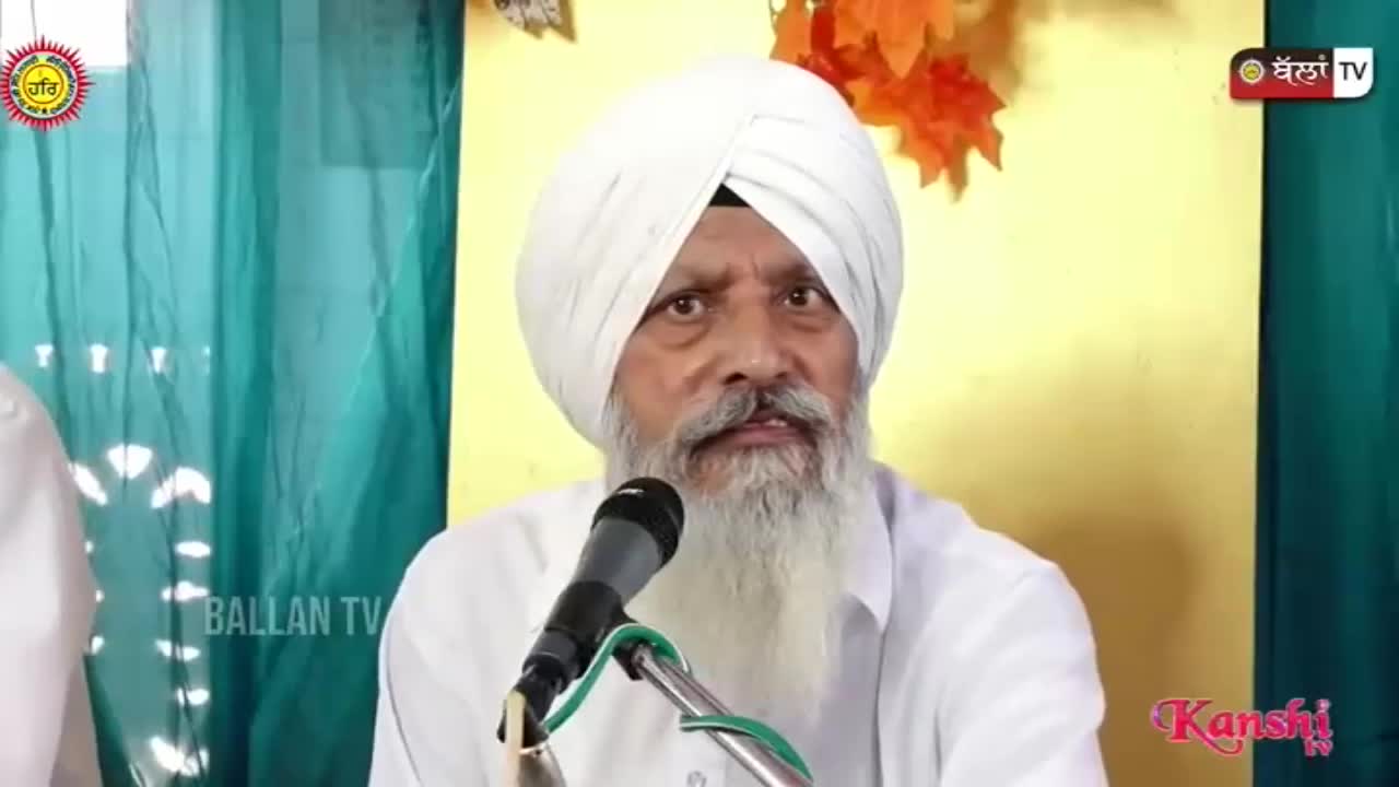 A man in a white turban and beard speaks into a microphone, his face lit by the camera. The Kanshi TV logo is visible in the corner, and the background is a simple curtain.
A man in a white turban and beard speaks into a microphone, his face lit by the camera. The Kanshi TV logo is visible in the corner, and the background is a simple curtain.