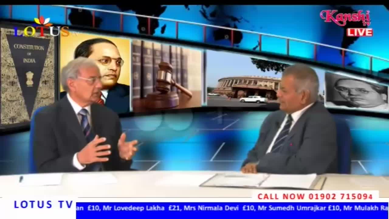Two men in suits are seated at a table, animatedly discussing something on Kanshi TV, a broadcast originating from the United Kingdom. Behind them, images of Indian political figures and the Constitution of India are displayed.
Two men in suits are seated at a table, animatedly discussing something on Kanshi TV, a broadcast originating from the United Kingdom. Behind them, images of Indian political figures and the Constitution of India are displayed.