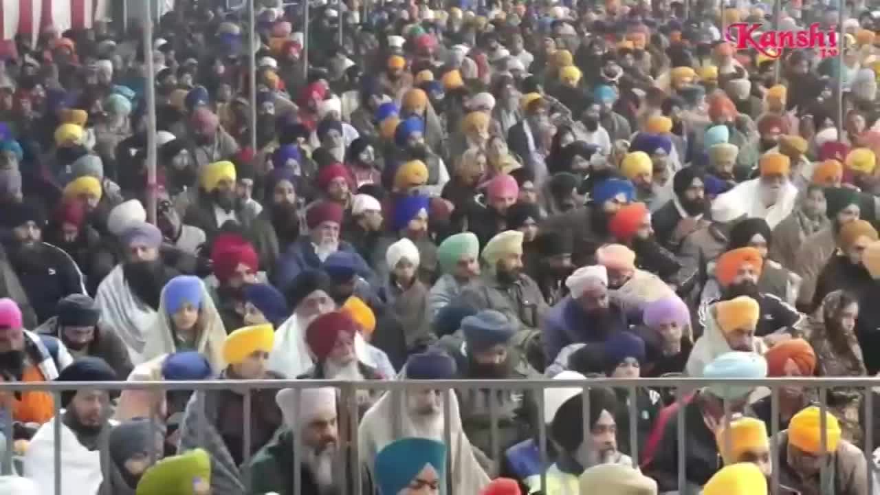 A large crowd, many wearing turbans of various colors, fills the space. The Kanshi TV logo is visible in the corner as the people appear to be watching something.
A large crowd, many wearing turbans of various colors, fills the space. The Kanshi TV logo is visible in the corner as the people appear to be watching something.