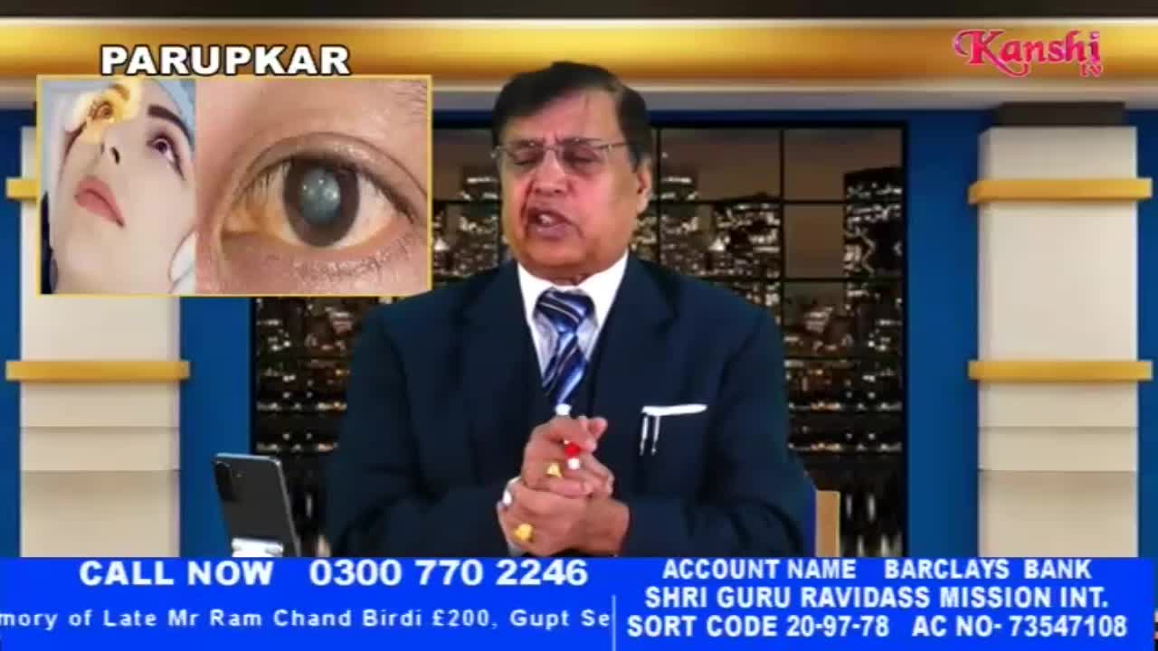 A man in a suit speaks directly to the camera, holding a few small objects in his hands. To his left, a split screen displays a close-up of an eye and a woman's face. The Kanshi TV logo is visible in the upper right corner.