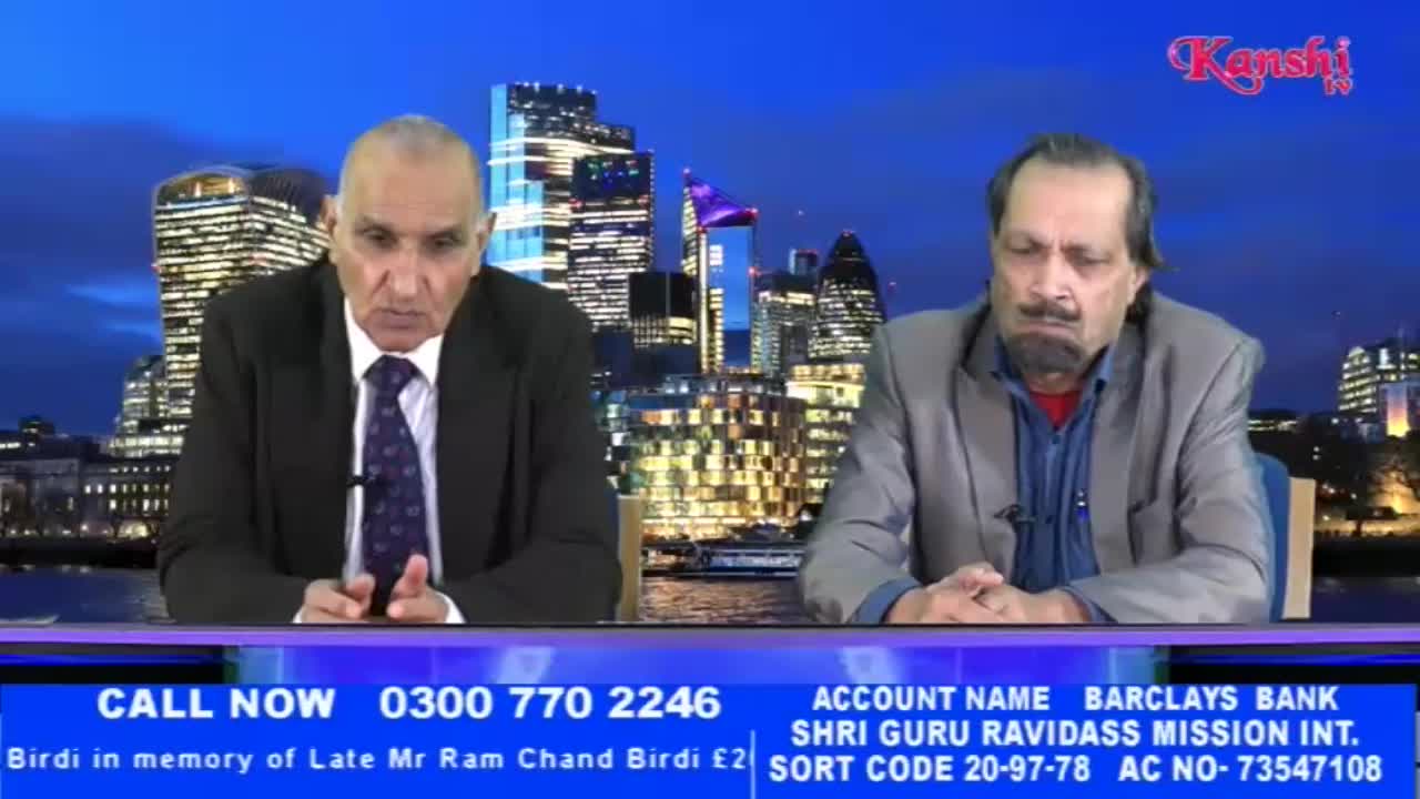 Two men sit at a table with a London skyline behind them, likely for a Kanshi TV broadcast. A phone number and bank details are displayed at the bottom of the screen.
