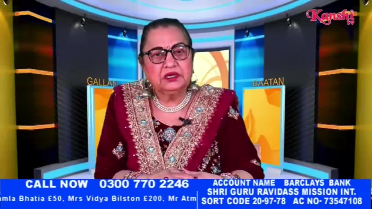 A woman in a richly embroidered maroon outfit speaks directly to the camera. The Kanshi TV logo is visible in the upper right corner.