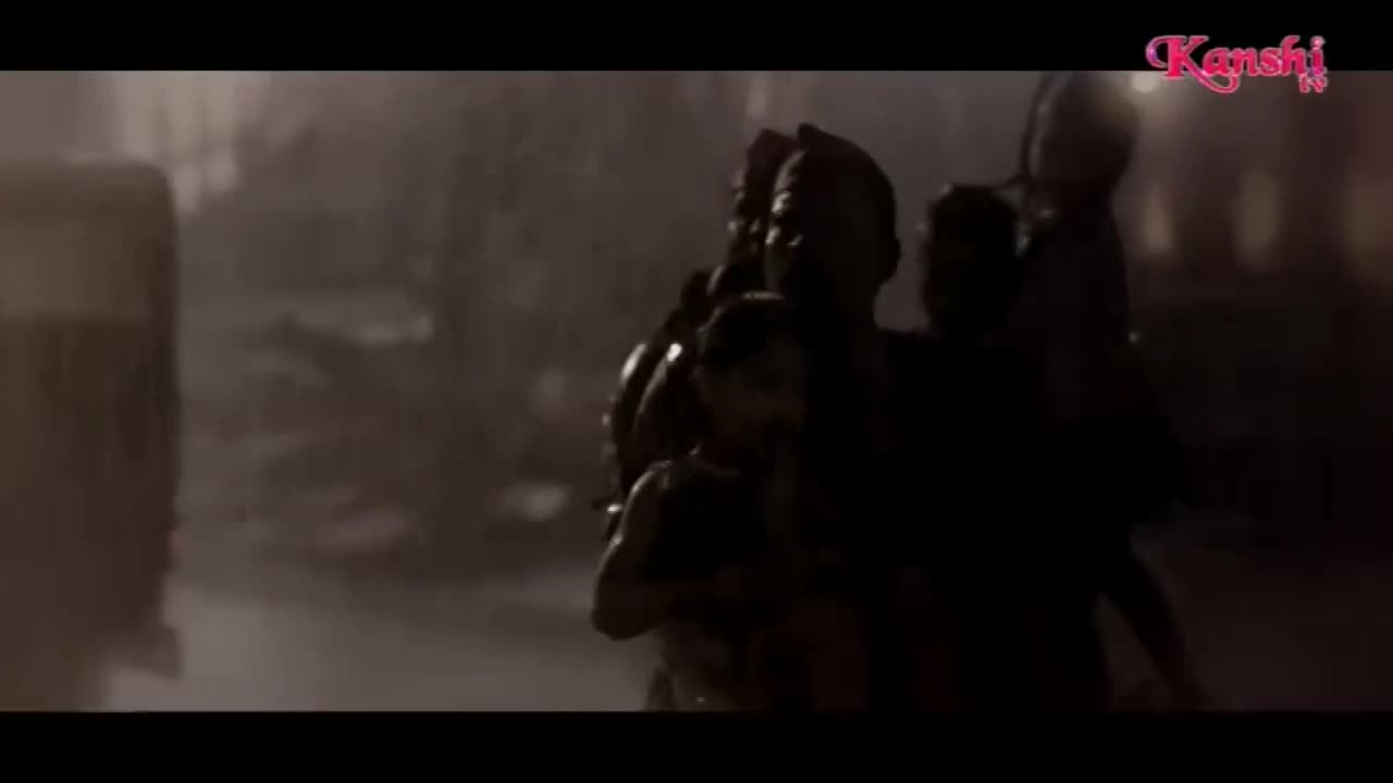 A group of people, silhouetted against a hazy background, are moving forward. One person carries a child on their shoulders, their faces obscured by shadow.