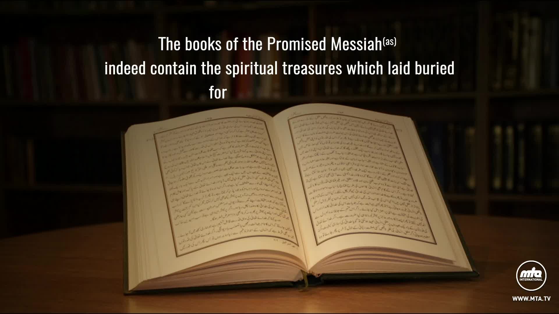 An open book rests on a wooden surface, its pages filled with script. Above, text from MTA1 World in the United Kingdom declares the book's significance.
