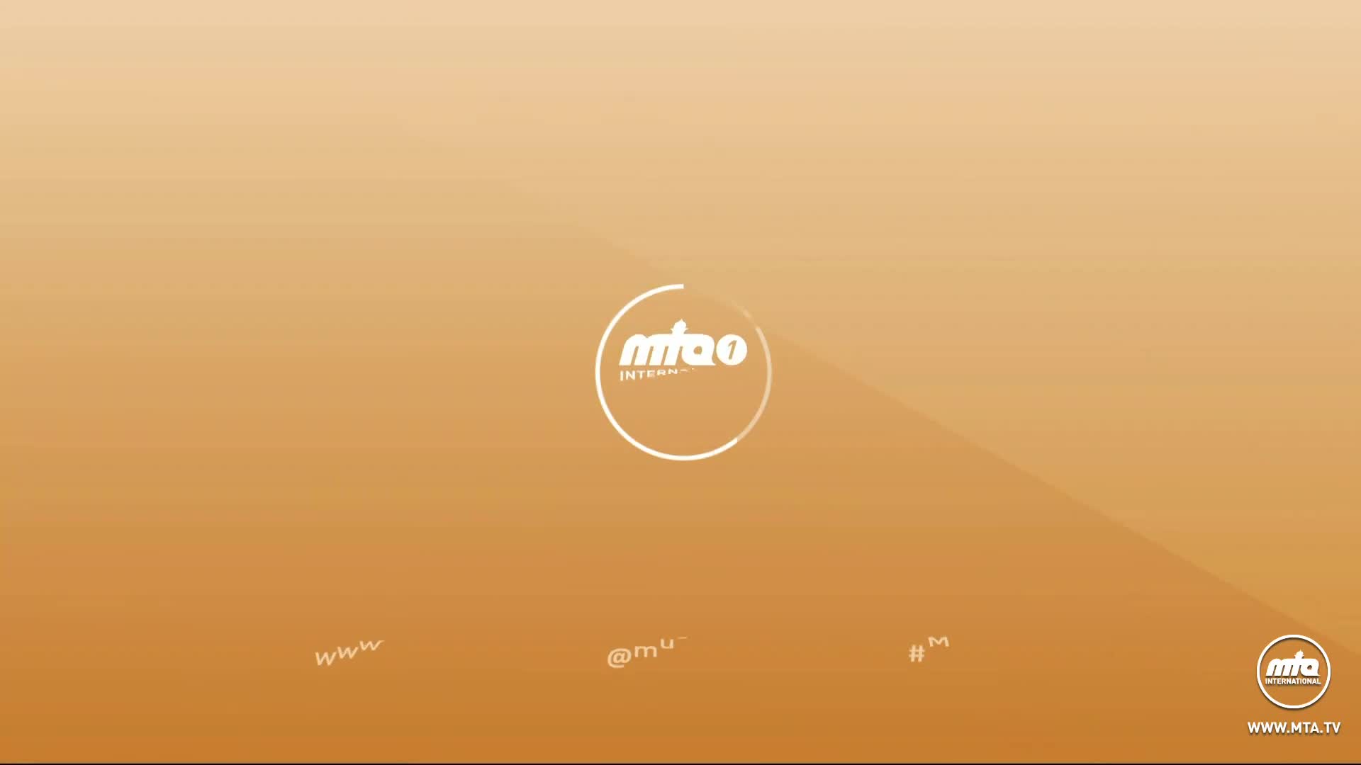 The MTA International logo, a white circle with text, floats against a warm, gradient background. Below, small white text, including "www" and "@mu," appears at the bottom of the screen.
