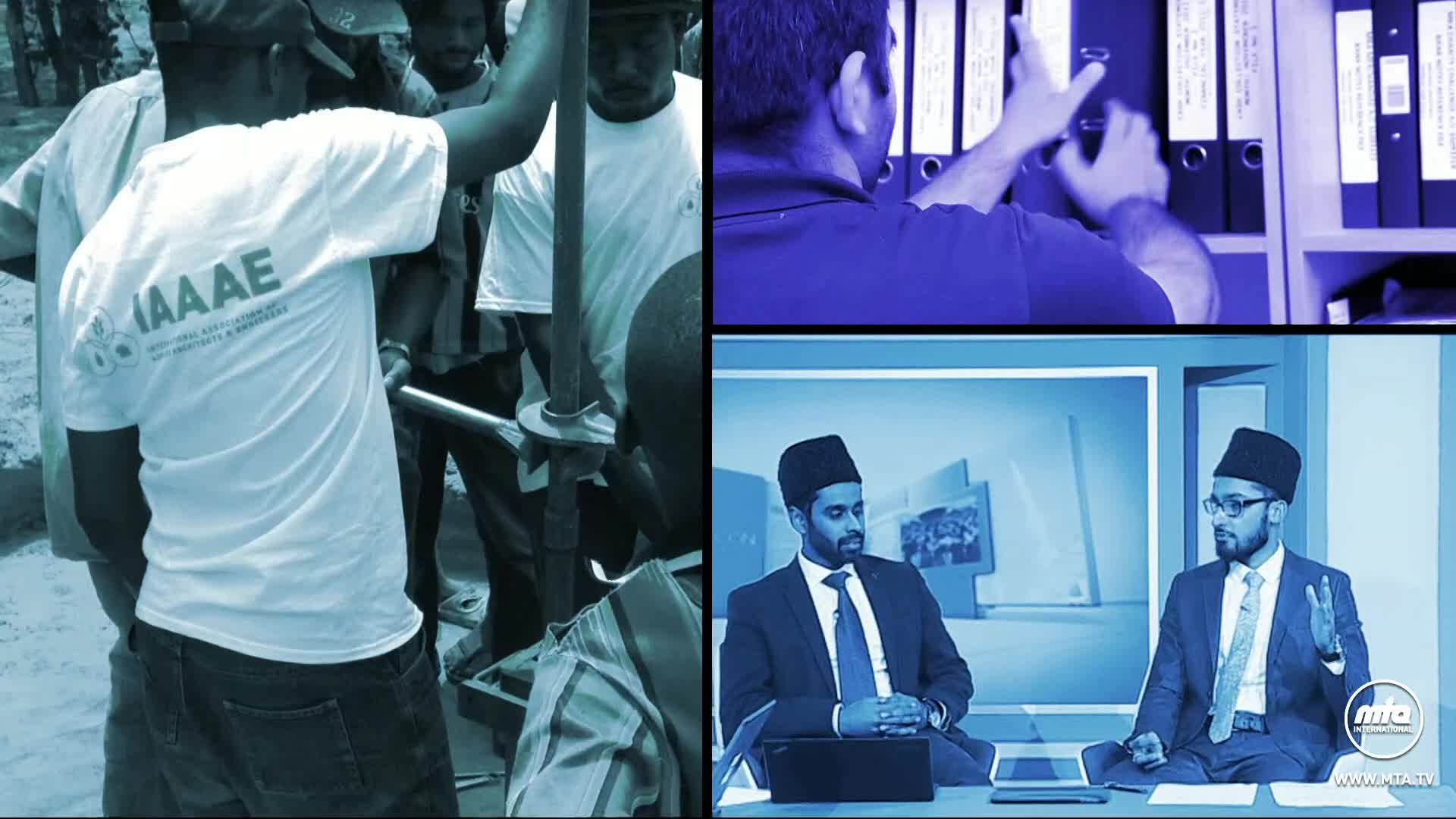 A group of men are gathered, working with a metal tool, while someone in a white t-shirt with the IAAAE logo is assisting.  On a screen, two men in suits and hats are seated at a table, speaking on MTA1 World.
