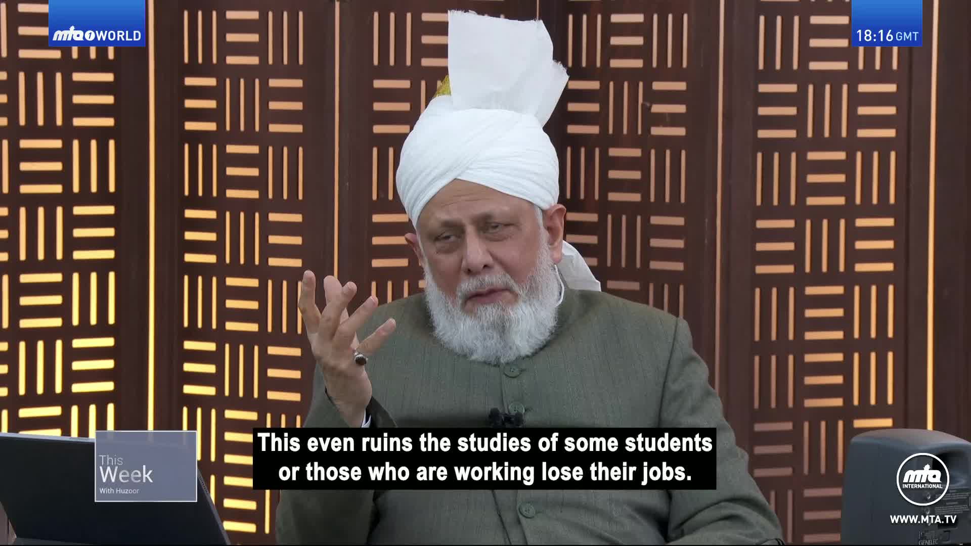 He's speaking on MTA1 World, gesturing with his hands as he talks. A caption below the speaker highlights the topic of discussion.
