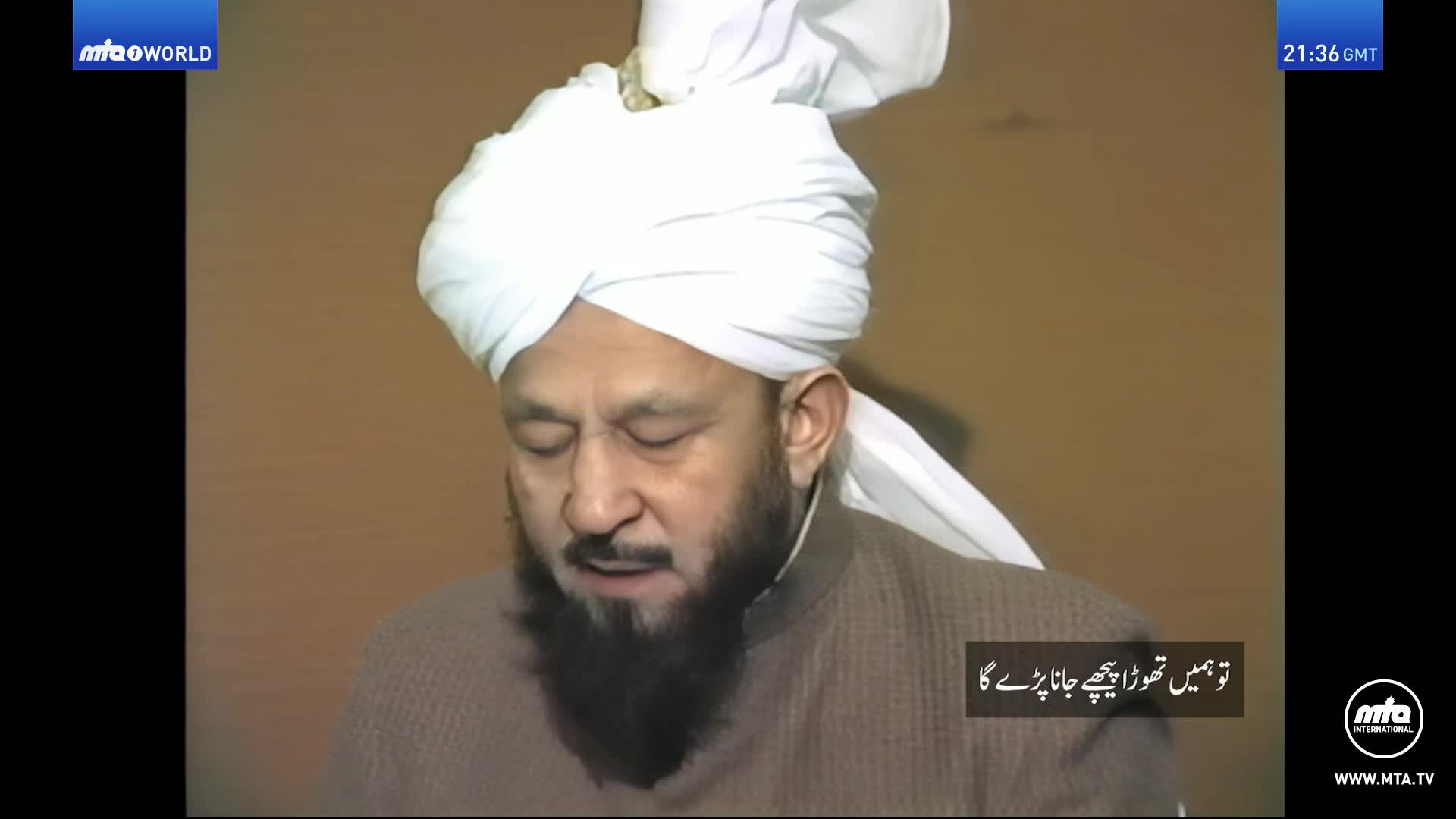 A man with a white turban and a beard speaks, his eyes closed. The MTA World logo appears in the top left corner, and the time is 21:36 GMT.