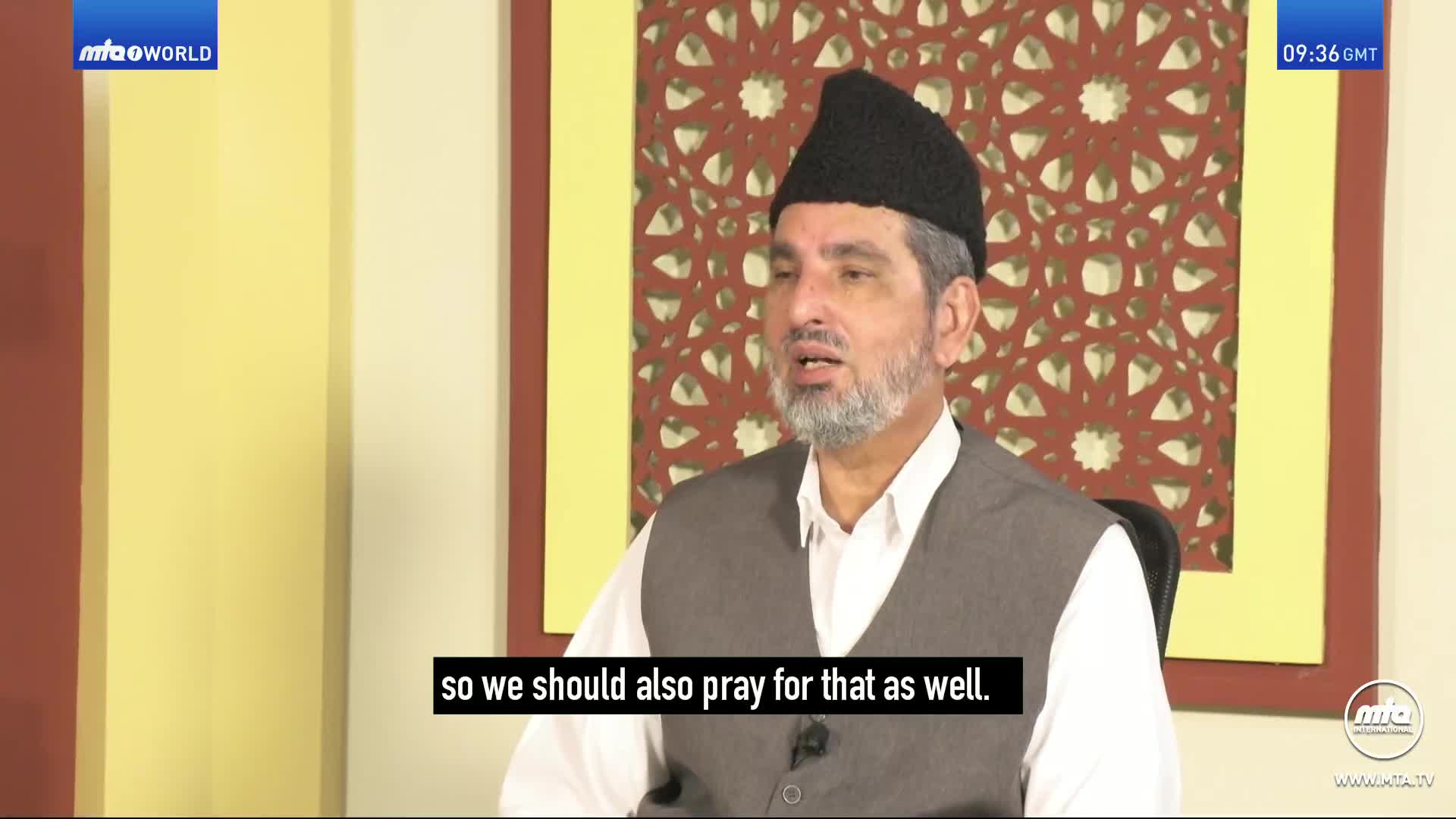 A man in a black cap and grey waistcoat speaks, his words subtitled. The MTA World logo appears in the top left corner.