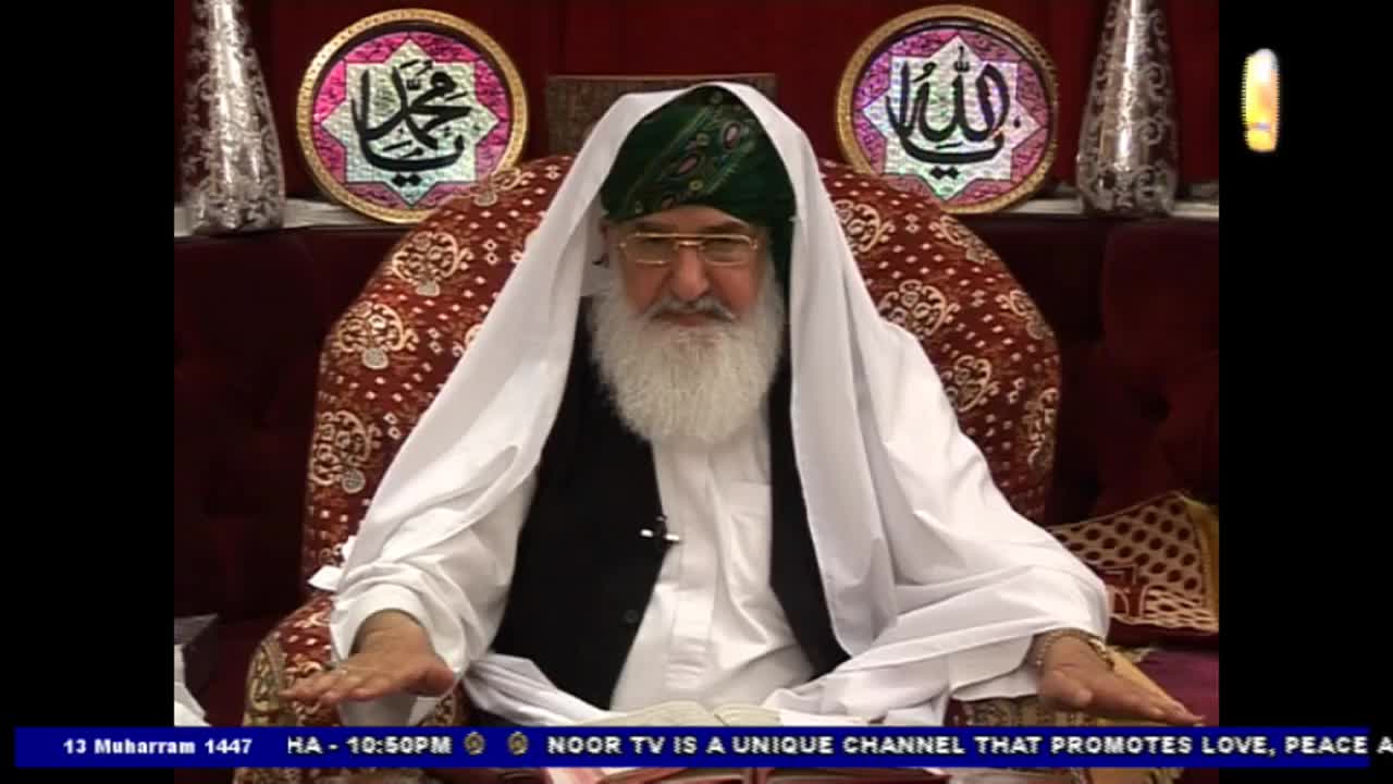 A man with a long white beard and glasses sits in a chair, his hands resting in front of him. He's wearing a white head covering and a black vest, and the Noor TV logo is visible at the bottom of the screen.
