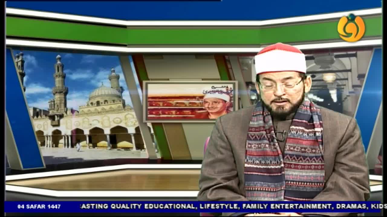 A man in a red and white cap and patterned scarf speaks, framed by a set with a mosque backdrop.  The Noor TV logo is visible in the corner.
