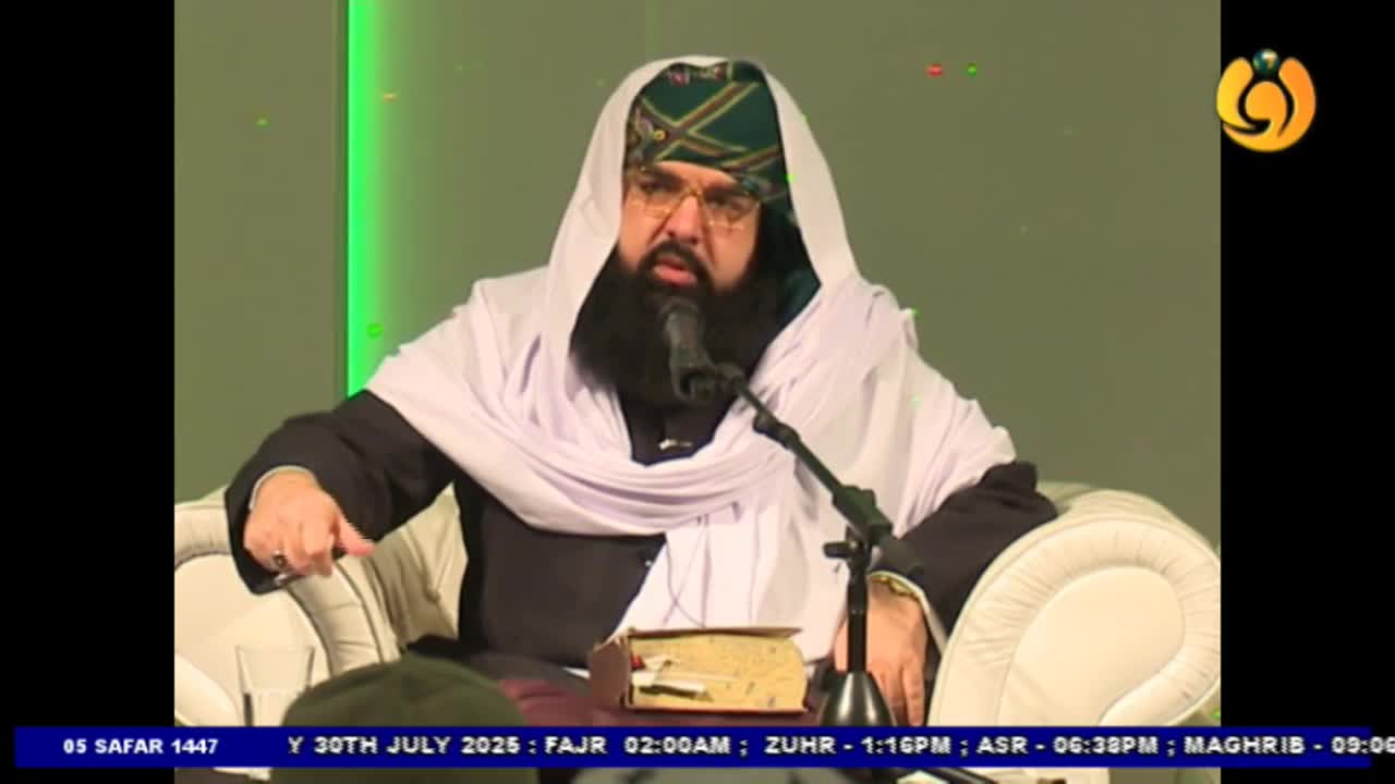 A man in a turban and shawl gestures with his hand, speaking into a microphone. The Noor TV logo is visible in the corner, and the date and prayer times are displayed at the bottom of the screen.
