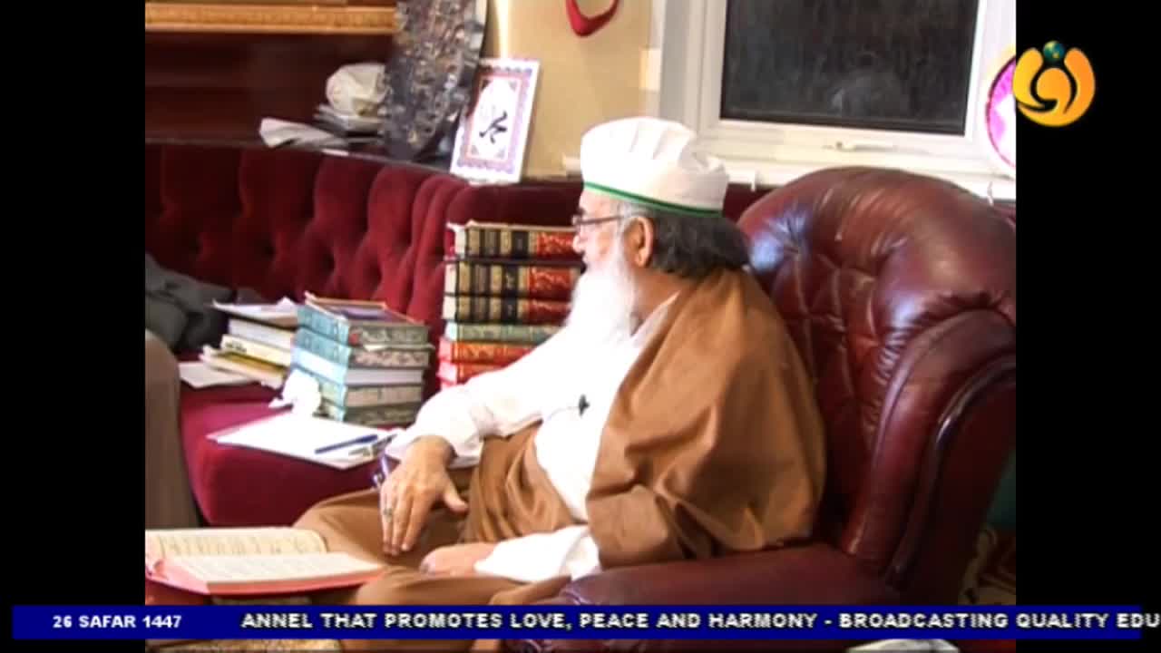 A man with a long white beard sits in a leather armchair, reading from a book. The Noor TV logo is in the corner, and the broadcast is from the United Kingdom.
