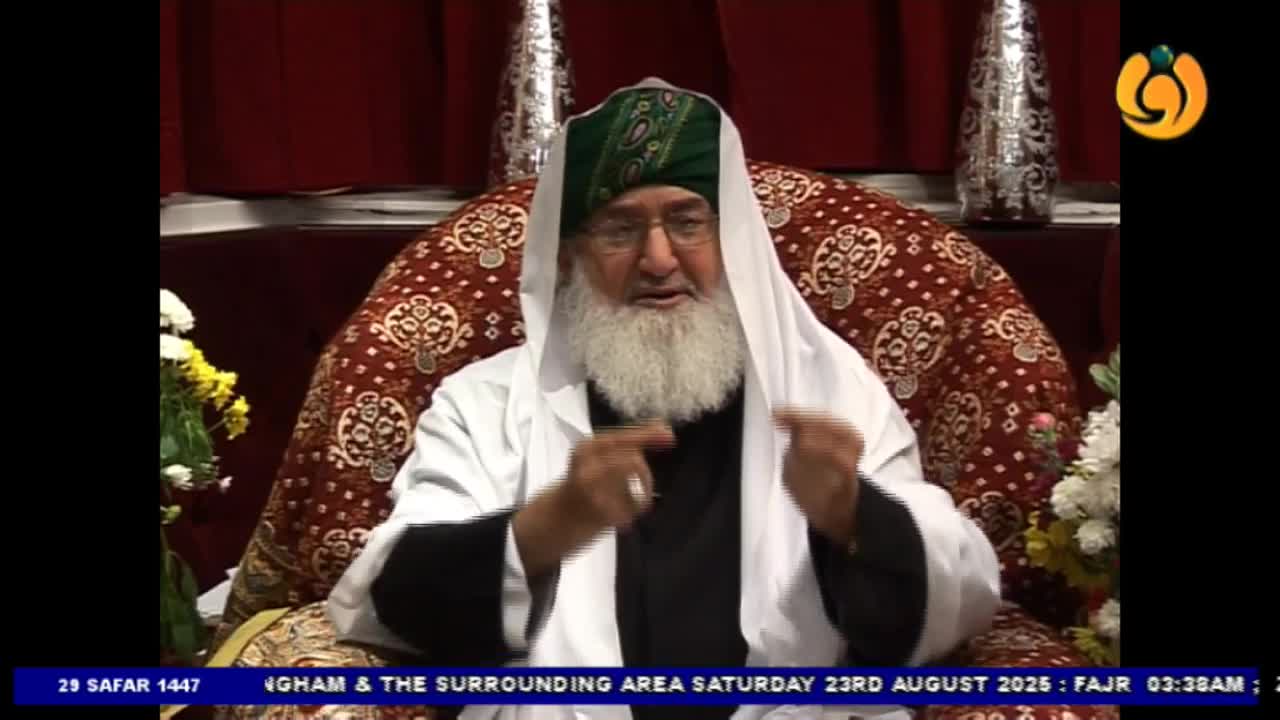 A man in a white robe and a green turban gestures with both hands, speaking. The Noor TV logo is visible in the corner, and the date and time are displayed at the bottom of the screen.
